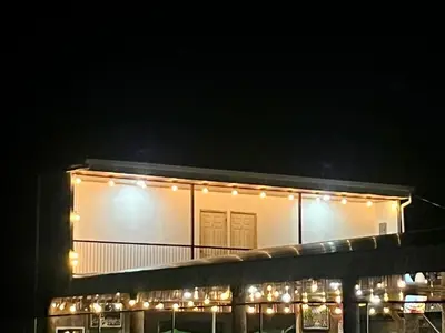 a building with lights on it at night at Luisito steak House & Hotel in Fortuna