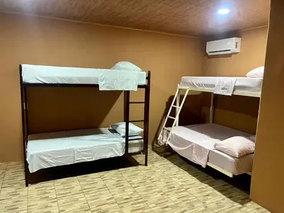 two bunk beds in a room with a wall at Luisito steak House & Hotel in Fortuna