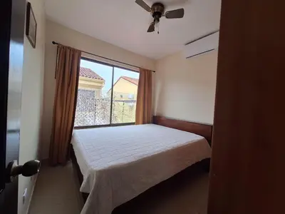 a small bedroom with a bed and a window at Villa Prados del Rio 47 in Comunidad