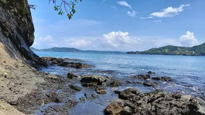 a view of the ocean with rocks in the water at Villa Prados del Rio 47 in Comunidad