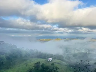 a house on top of a hill in the clouds at Aves Monteverde Eco Lodge con jacuzzi in La Cruz