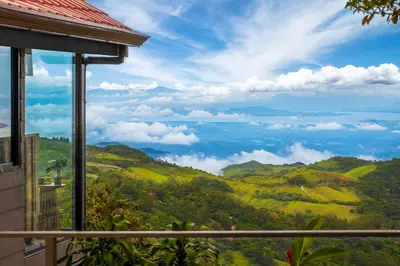 a view of the mountains from a house at Aves Monteverde Eco Lodge con jacuzzi in La Cruz