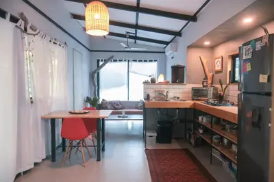 a kitchen with a counter and a table and a refrigerator at Jungle house in Santa Teresa in Santa Teresa Beach
