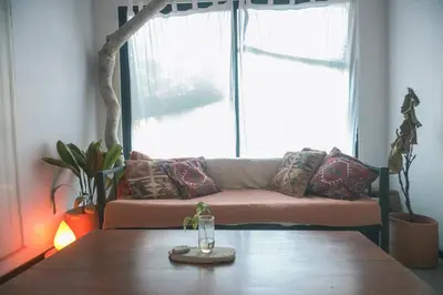 a living room with a couch and a wooden table at Jungle house in Santa Teresa in Santa Teresa Beach