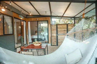 a hammock on a porch of a house at Jungle house in Santa Teresa in Santa Teresa Beach