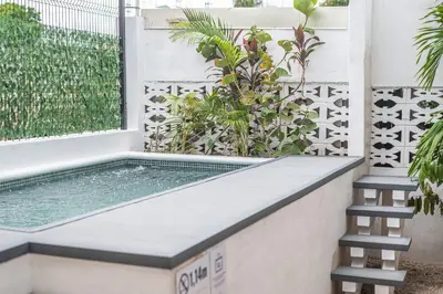 a swimming pool in a house with two stairs at Japandi Tropical Stay in Puntarenas