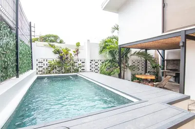 a swimming pool on the balcony of a house at Japandi Tropical Stay in Puntarenas