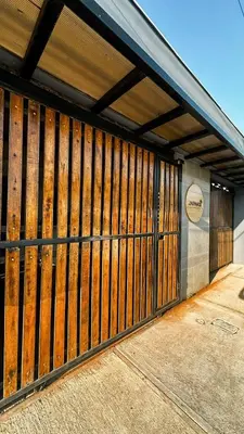 a wooden fence on the side of a building at Japandi Tropical Stay in Puntarenas