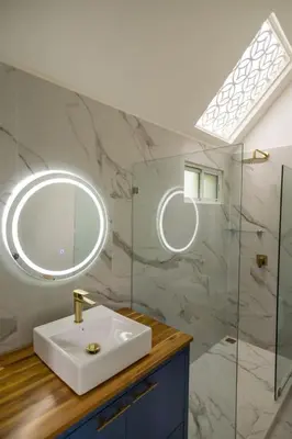 a bathroom with a sink and a mirror at Modern 2BR Home in Central Manuel Antonio! in Quepos