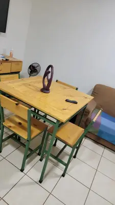 a wooden table with a pair of chairs and a bench at Playas del Coco Cocomarindo 23 in Coco