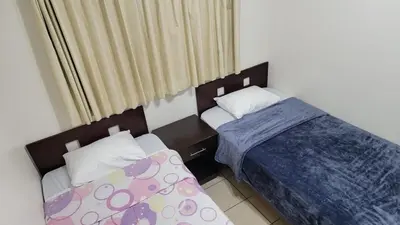 a bedroom with two beds and a window at Playas del Coco Cocomarindo 23 in Coco