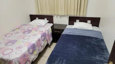 two beds in a small room withskirts at Playas del Coco Cocomarindo 23 in Coco