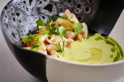 a bowl of food with shrimp and green onions at Ocotea Boutique Hotel in Monteverde Costa Rica