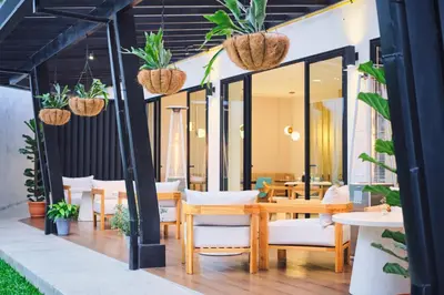 a patio with a table and chairs and plants at Ocotea Boutique Hotel in Monteverde Costa Rica