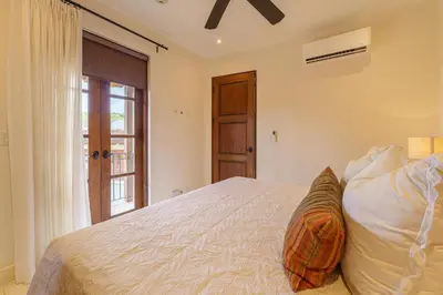 a bedroom with a large bed and a window at Casa Brisa At Las Catalinas in Playa Danta