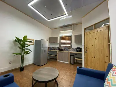 a kitchen with a table and a refrigerator at Apt Barrio Mexico in San José