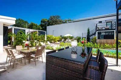 an outdoor patio with a table and chairs at Nomad Containers - Adults only in Tamarindo