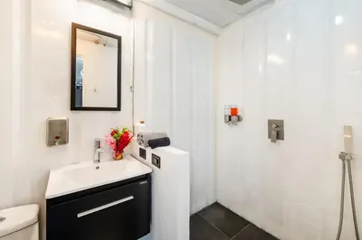 a white bathroom with a sink and a mirror at Nomad Containers - Adults only in Tamarindo