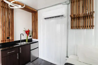 a small kitchen with a sink and a sink at Nomad Containers - Adults only in Tamarindo