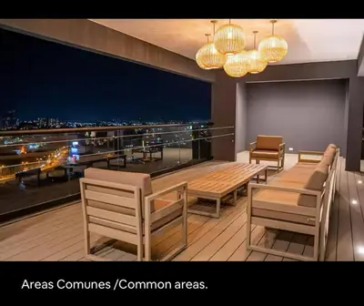 a restaurant with tables and chairs and a view of the city at Luxury Loft in San Jose CR in San José