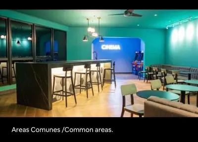 a restaurant with a bar with chairs and tables at Luxury Loft in San Jose CR in San José