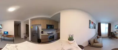 a kitchen and living room with an arch in the wall at Luxury Loft in San Jose CR in San José