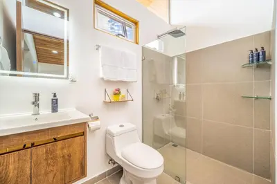 a bathroom with a toilet and a sink and a shower at Macondo Ecolodge Alpinias - Veranera in Coco
