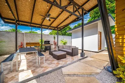 an outdoor patio with a wooden pergola at Macondo Ecolodge Alpinias - Veranera in Coco