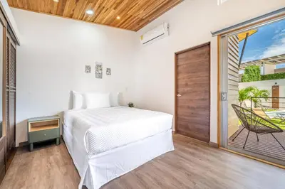 a bedroom with a bed and a balcony at Macondo Ecolodge in Coco
