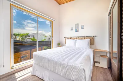 a bedroom with a bed and a large window at Macondo Ecolodge in Coco