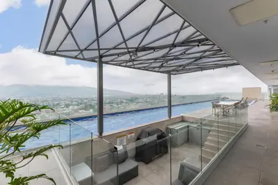 a view of a swimming pool from a house at Urban Breeze iFreses, 10th floor! AC, TV and Pool in Guayabos