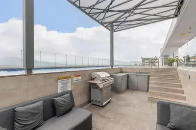 an office with a couch and a printer on a building at Urban Breeze iFreses, 10th floor! AC, TV and Pool in Guayabos