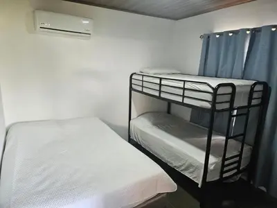 a small room with two bunk beds in it at Paso de las Lapas in Uvita