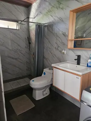 a bathroom with a toilet and a sink at Paso de las Lapas in Uvita
