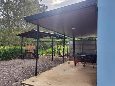 a pavilion with a table and chairs under it at Paso de las Lapas in Uvita
