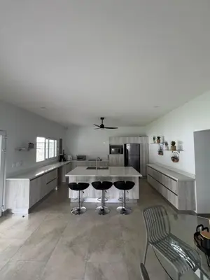 a large kitchen with a table and chairs in it at Casa fortuna 777 in Agua Azul