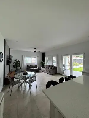 a kitchen and living room with a table and chairs at Casa fortuna 777 in Agua Azul