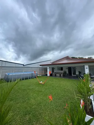 a house with a yard with a hose at Casa fortuna 777 in Agua Azul