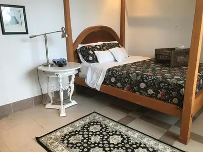 a bedroom with a bed and a table with a lamp at La Serenidad in Tronadora