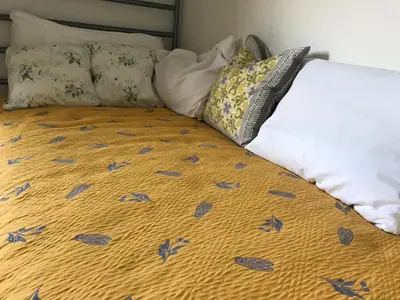 a bed with some pillows on top of it at La Serenidad in Tronadora