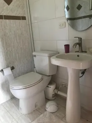 a bathroom with a toilet and a sink at La Serenidad in Tronadora