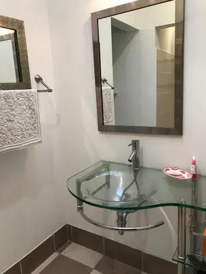 a glass sink in a bathroom with a mirror at La Serenidad in Tronadora