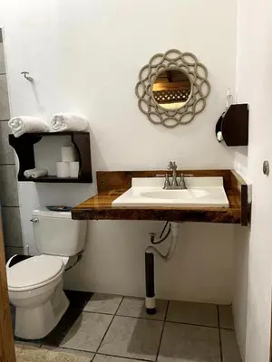 a bathroom with a sink and a toilet at Cabinas Mi Sol in Uvita