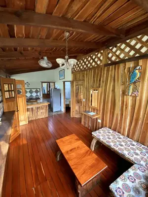 a living room with a bench and a table in a cabin at Cabinas Mi Sol in Uvita