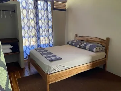 a small bed in a room with at Cabinas Mi Sol in Uvita