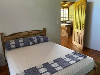 a bed with two pillows on it in a bedroom at Cabinas Mi Sol in Uvita