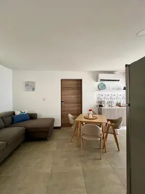 a living room with a table and a couch at Entire home with Private Pool - Coralita in Jaco, gated community, walking distance to Jaco Beach in Jacó