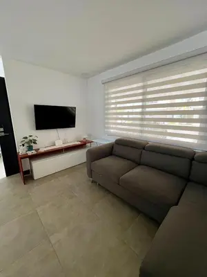 a living room with a couch and a flat screen tv at Entire home with Private Pool - Coralita in Jaco, gated community, walking distance to Jaco Beach in Jacó