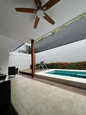 a patio with a swimming pool and a ceiling fan at Entire home with Private Pool - Coralita in Jaco, gated community, walking distance to Jaco Beach in Jacó