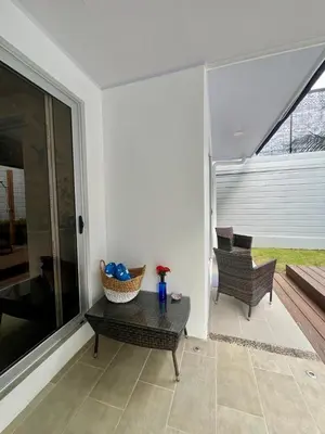 a living room with a table and a chair at Entire home with Private Pool - Coralita in Jaco, gated community, walking distance to Jaco Beach in Jacó